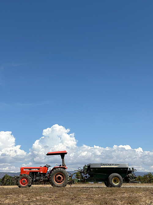 The tractor and compost spreader under bright blue skies, September 2025
