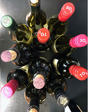 Top view of Hendry bottles with colorful screw-cap tops