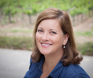 Tamara Landre standing in front of Block 3 vines
