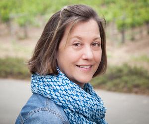 Therese Brown standing in front of Block 3 vines