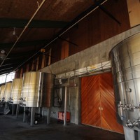 Stainless steel outdoor fermentation tanks with wood cellar door