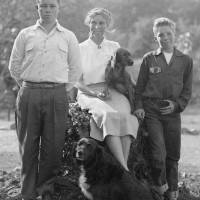 Black and white image of Margaret Hendry and her two sons with two dogs